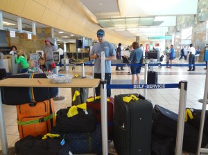 2nd Man trying to figure how to check 13 bags of crazy onto the plane